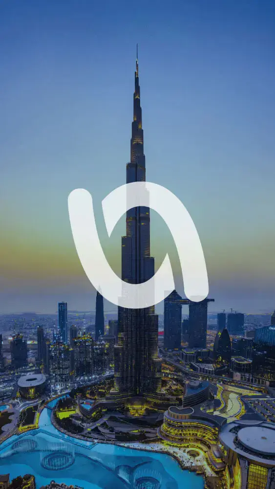 Logo of The Voucher App superimposed on an aerial view of the Burj Khalifa and surrounding cityscape during twilight